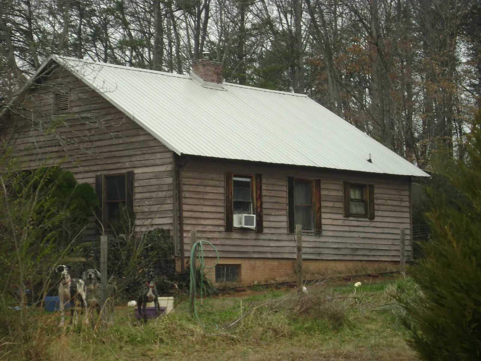 White metal roof on an old wood sided farmhouse, from a Metal Roof Installation job in East Greenbush
